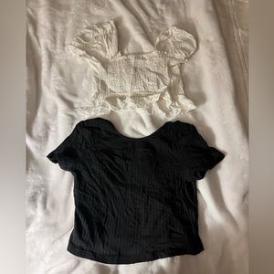 Two white and black crop top. White is lace and black is a stretchy material